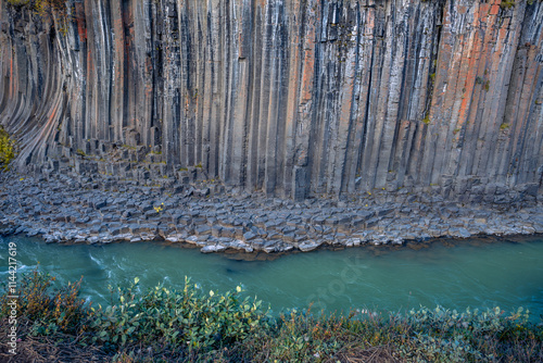 Basalt columns coloured orange by iron oxide, Studlagil Canyon, Egilsstadir, Austurland, Iceland photo