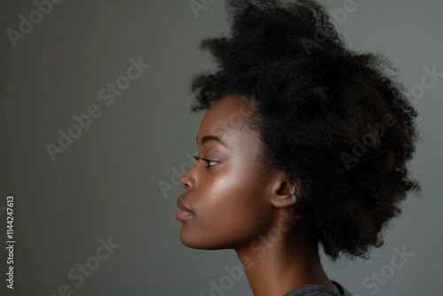 Close up profile portrait of african american young woman against gray background