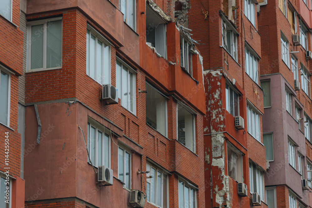 Fototapeta premium Russian missile hits residential building in Dnipro, Ukraine. Aftermath of enemy attack on city. Destroyed residential multi-story building. Close-up. War. Aftermath of explosion.