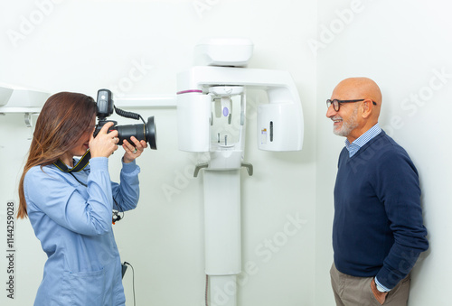 Dentist taking pictures of senior patient with professional camera in dental clinic photo