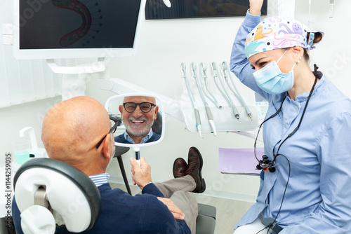 Senior man admiring his new smile after dental implant surgery