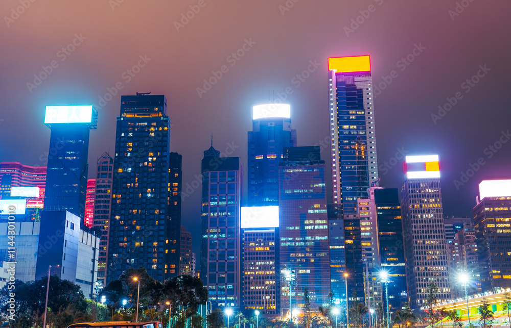 Naklejka premium Hong Kong at night view on skyscrapers silhouette buildings backlit light