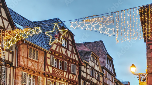 Quadro su tela Charming half-timbered houses adorned with decorations in a quaint village durin