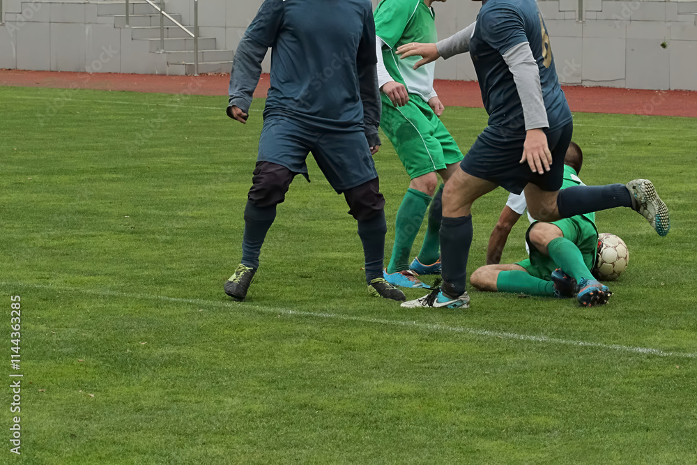 Obraz premium Soccer players on a football field during a foul, conflict during a soccer game, player sent off for breaking the rules in football.