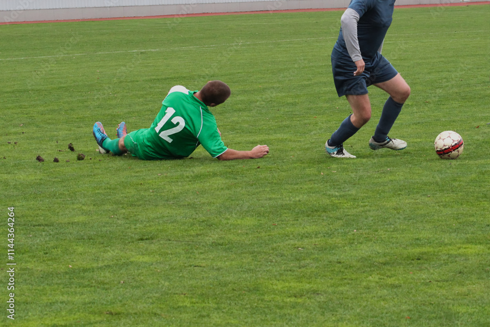 football team defender takes the ball from an opposing attacker Concept of professional sports, competition, tournament, energy, action, teams fighting football team defender takes the ball from an opposing attacker Concept of professional sports, competition, tournament, energy, action, teams fighting