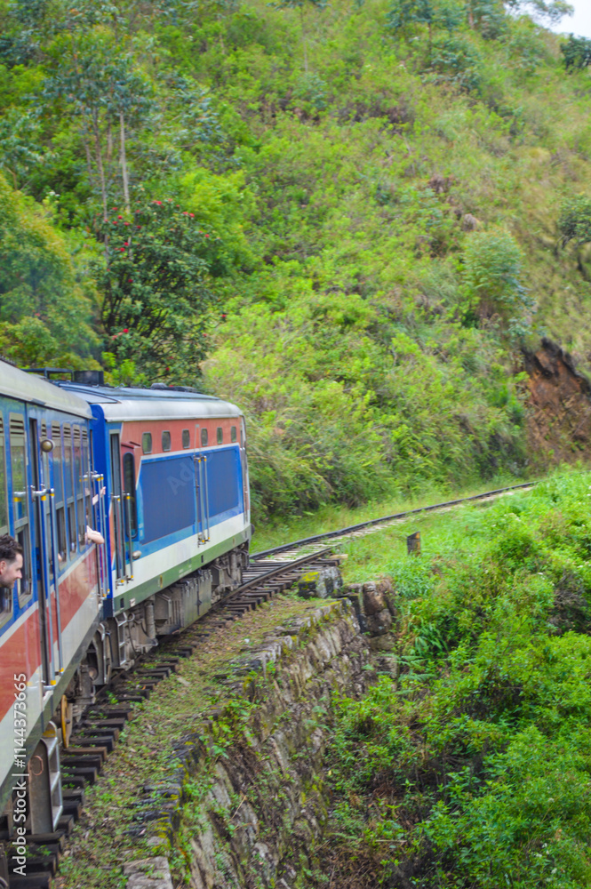 Naklejka premium Colonial train route built by the British Empire, offering a journey through history, stunning mountains, waterfalls, and tea estates—Ella Odyssey train journey 2024.12.13 Ella Sri Lanka