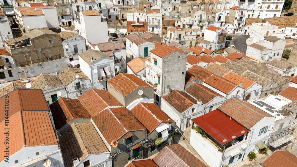 Aerial view of white houses, buildings and apartments in the historic center of Pisticci, in the province of Matera, Basilicata. It is a small hill town in southern Italy. Aerial view of white houses, buildings and apartments in the historic center of Pisticci, in the province of Matera, Basilicata. It is a small hill town in southern Italy.