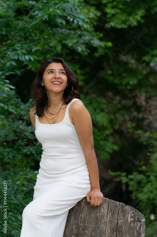 Latin woman posing in nature wearing a white dress Latin woman posing in nature wearing a white dress