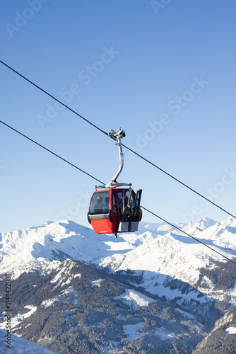 Red cable car over ski valley Gastein in Austrian Alps. Winter sport concept
