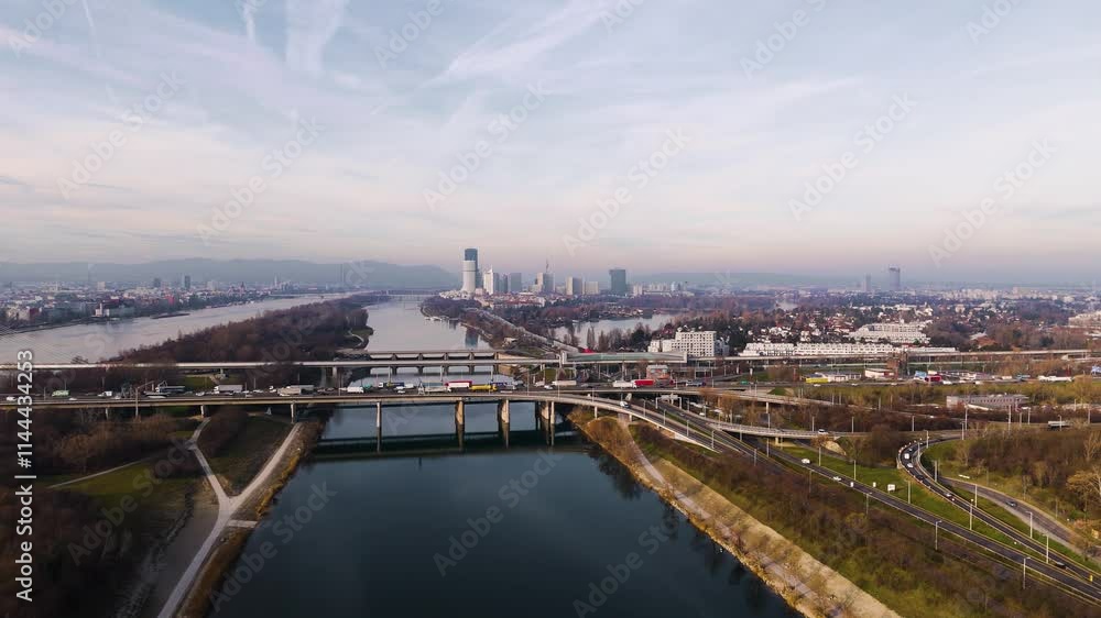 Austria, Vienna: Bridges Over the Danube River with Heavy Traffic. A dynamic aerial view showcasing the bustling flow of vehicles across Vienna's iconic bridges. Austria, Vienna: Bridges Over the Danube River with Heavy Traffic. A dynamic aerial view showcasing the bustling flow of vehicles across Vienna's iconic bridges.
