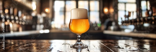 Golden beer in a glass resting on rustic wooden bar in a lively pub environme...
