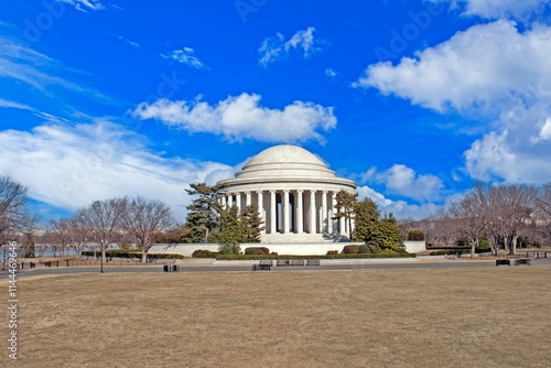 Scenic view of the Jefferson Memorial with clear blue skies and trees in Washington DC photo