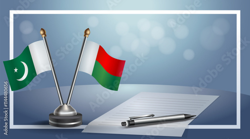 Pakistan and Madagascar National flags on small table with bokeh background, cooperative relationship