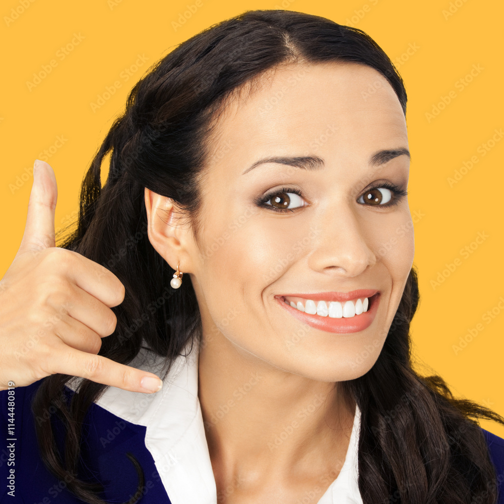 Businesswoman in black confident suit showing call me hand sign gesture, isolate orange yellow background. Portrait of happy smile gesturing brunette woman at studio. Business concept. Square image. Businesswoman in black confident suit showing call me hand sign gesture, isolate orange yellow background. Portrait of happy smile gesturing brunette woman at studio. Business concept. Square image.