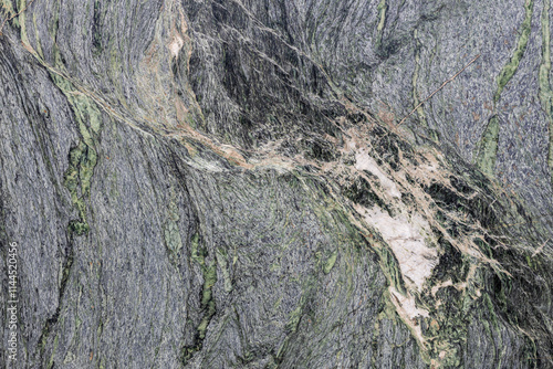 A fragment of natural gray-green marble, granite slab with interesting patterns
