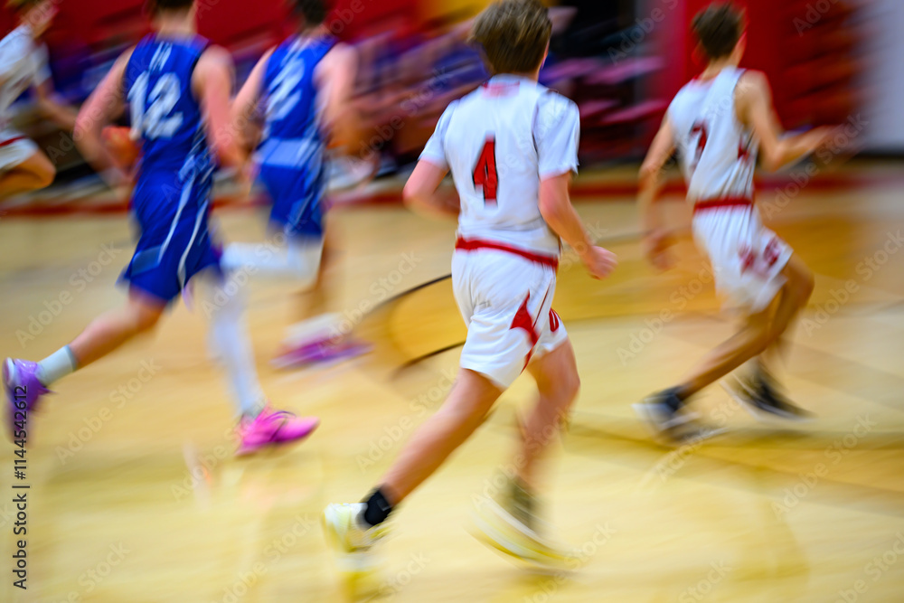 High School Basketball with motion blur showing the speed and movement of the young boys playing the game at Oxford HS in Upstate NY High School Basketball with motion blur showing the speed and movement of the young boys playing the game at Oxford HS in Upstate NY