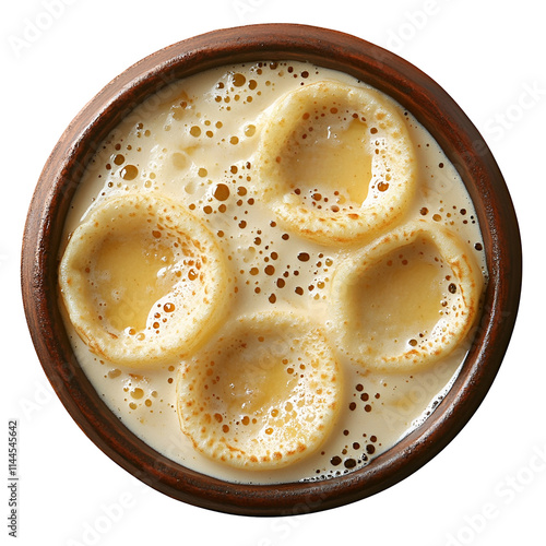 Top view of an extremely perfect looking vattayappam in a dark clay plate isolated on a white transparent background photo