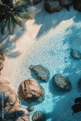 Serene tropical beach with turquoise waters and rocky formations seen from ab...
