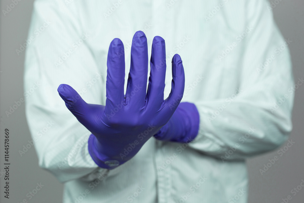 Doctor wearing nitrile gloves, isolated on grey background. medical, surgeon, sterile, pharmaceutical concept Doctor wearing nitrile gloves, isolated on grey background. medical, surgeon, sterile, pharmaceutical concept