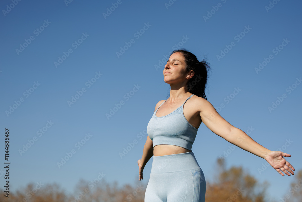 Photo of a beautiful young woman breathing and meditating in a park after doing her mindful exercises, yoga, pilates, running. Photo of a beautiful young woman breathing and meditating in a park after doing her mindful exercises, yoga, pilates, running.