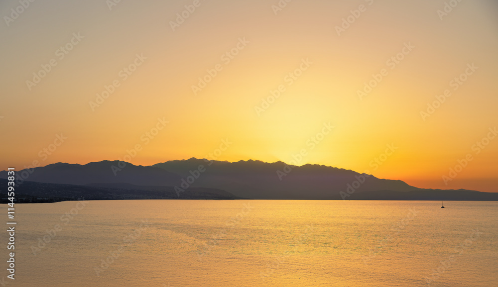Coastline with Cretan Sea at sunset in late summer on the island of Crete in Greece Coastline with Cretan Sea at sunset in late summer on the island of Crete in Greece