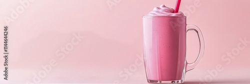 Delicious pink smoothie topped with fresh raspberries served in a clear glass...