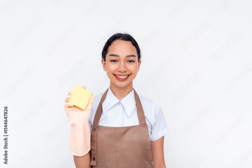 A young cheerful female asian housekeeper holding a yellow sponge for cleaning. Isolated on a white background. A young cheerful female asian housekeeper holding a yellow sponge for cleaning. Isolated on a white background.