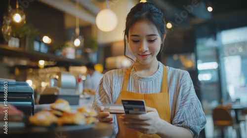 Online shopping concepts, Young asian woman making online payment with credit card through smart phone in restaurant, Mobile banking and financial