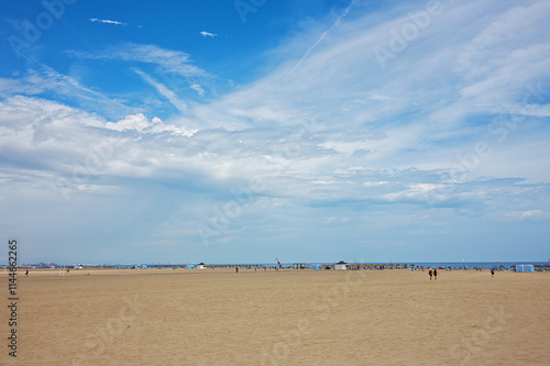 Beach with big surface of sand under the blue cloudy sky #1144662265