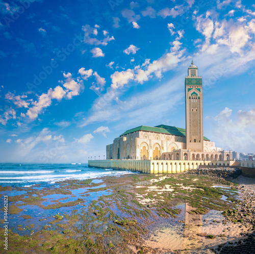 Spectacular view of the iconic Hassan II Mosque on the rugged shores of the Atlantic ocean along the Corniche promenade in Casablanca, Morocco photo