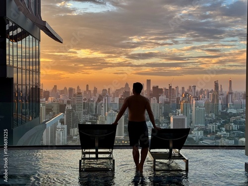 Rooftop swimming pool with the downtown  skyscraper skyline.