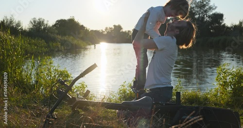 Father with Son Spend Together Happy Evening Time on Nature Watching Sunset Above Lake. 4K 10-bit