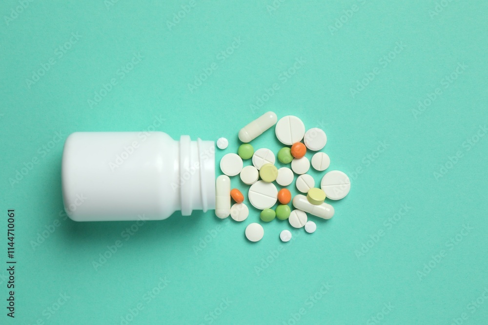 Various pills pouring out of medicine bottle on color background Various pills pouring out of medicine bottle on color background