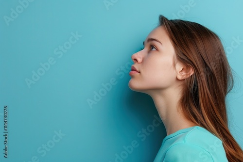 Attractive girl with copy space on blue background portrait. photo