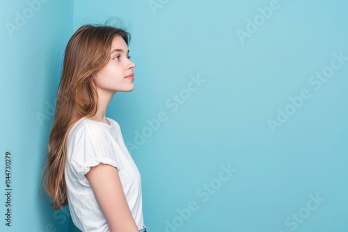 Attractive girl with copy space on blue background portrait.