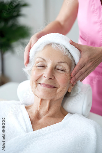Senior woman enjoying a relaxing facial massage in a spa setting.