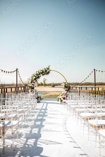 round arch of white flowers and greenery on the background of nature. wedding day