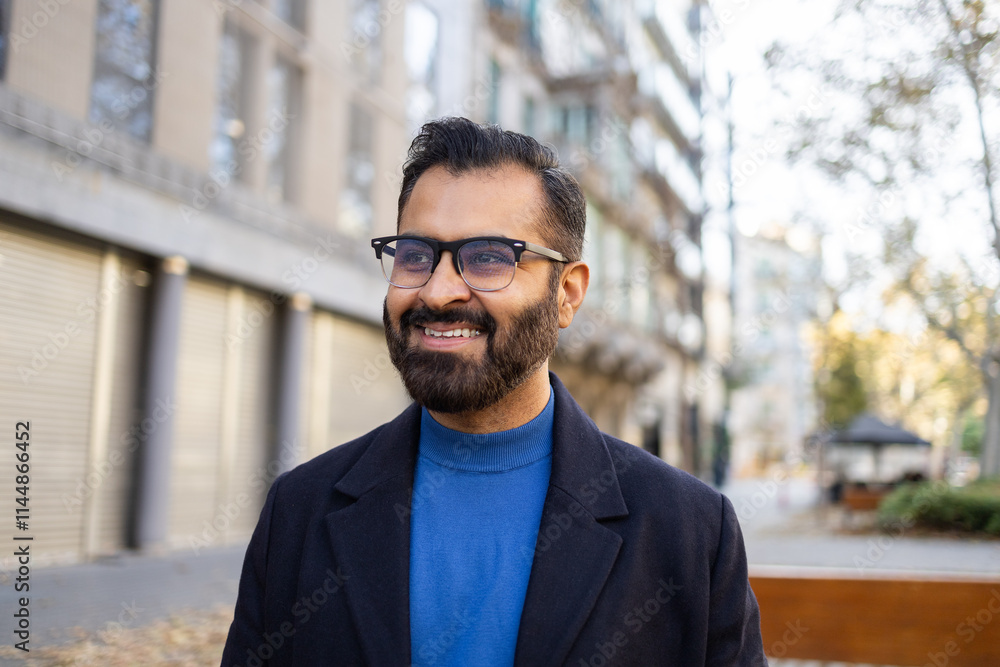Indian businessman enjoying a sunny winter day outdoors Indian businessman enjoying a sunny winter day outdoors