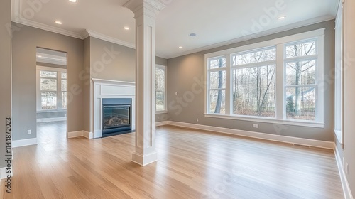 Empty interior with fireplace, window, and wood floor.