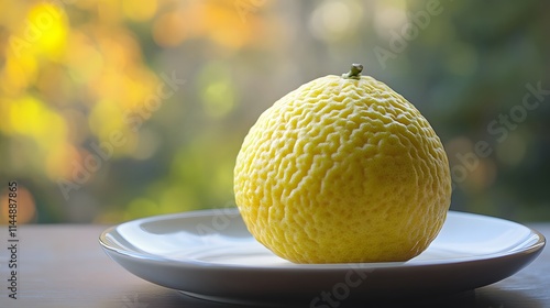 image of a Osage orange on a plate, set against a soft, blurred background photo