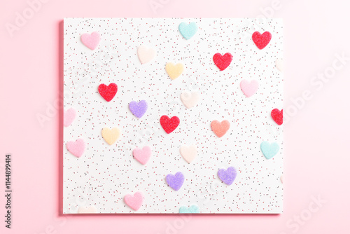 Colorful hearts on textured white background with red dots photo