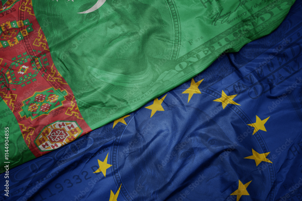 waving colorful flag of turkmenistan and national flag of european union on the dollar money background. finance concept. waving colorful flag of turkmenistan and national flag of european union on the dollar money background. finance concept.