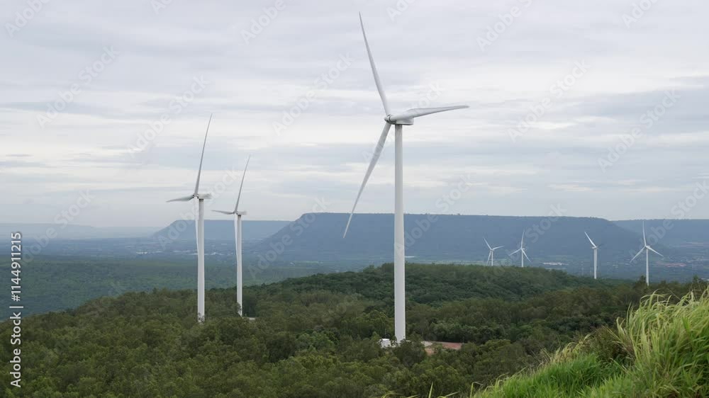 Progressive way of utilizing wind as renewable source of energy to power the modern way of life by wind turbine farm on green field or hill. Windmill generator generate electric with no CO2 emission. Progressive way of utilizing wind as renewable source of energy to power the modern way of life by wind turbine farm on green field or hill. Windmill generator generate electric with no CO2 emission.