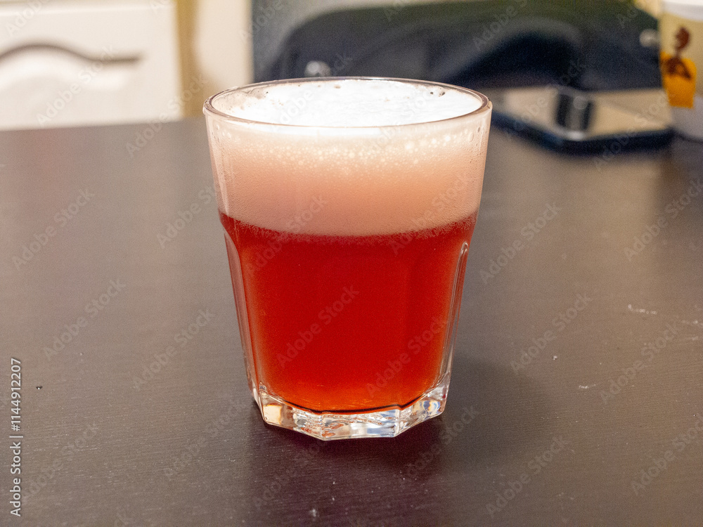 glass of fruit beer on table glass of fruit beer on table
