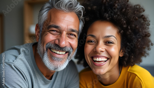  Smiling older man and young woman close-up indoors.