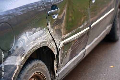 Obraz na płótnie Crumpled rear fender with dents and scratches, damaged car's arch and body paint after road collision. Dented rear door. Scratches and dents on car rear fender, damaged paint after side impact w salonie