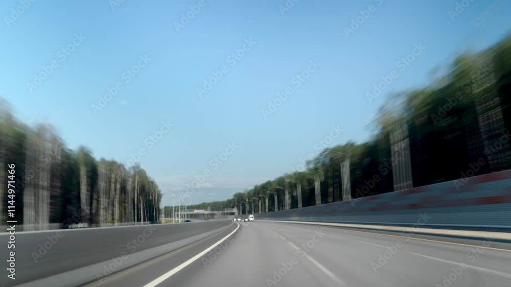 A beautiful scenic highway view featuring a car driving under a clear blue sky A beautiful scenic highway view featuring a car driving under a clear blue sky