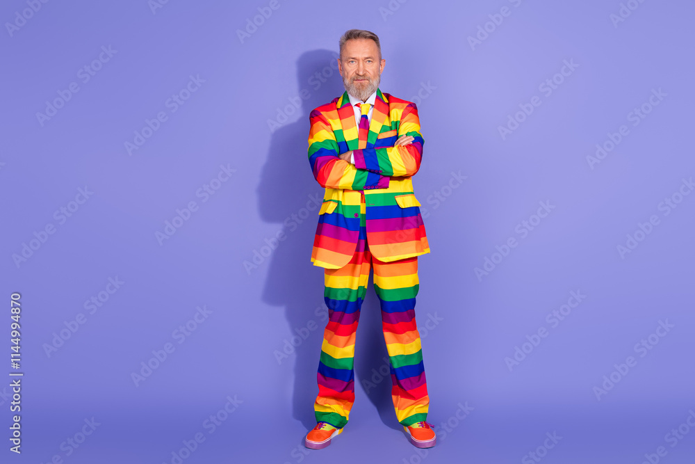 Charismatic older man in rainbow striped suit, standing confidently against a purple backdrop embodying fashion, pride, and individuality Charismatic older man in rainbow striped suit, standing confidently against a purple backdrop embodying fashion, pride, and individuality