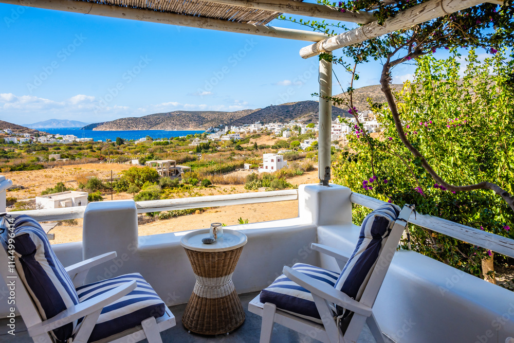 Two chairs and coffee table on terrace of a traditional Greek style apartment in Katapola village, Amorgos island, Cyclades, Greece