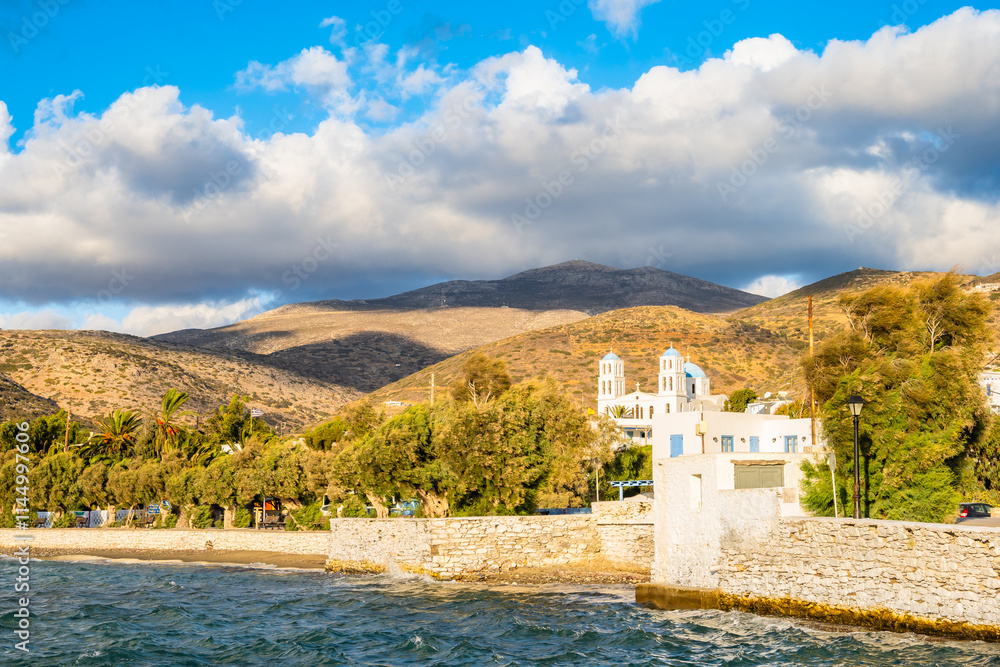 View of church building on sea coast in Katapola port at sunset time, Amorgos island, Cyclades, Greece